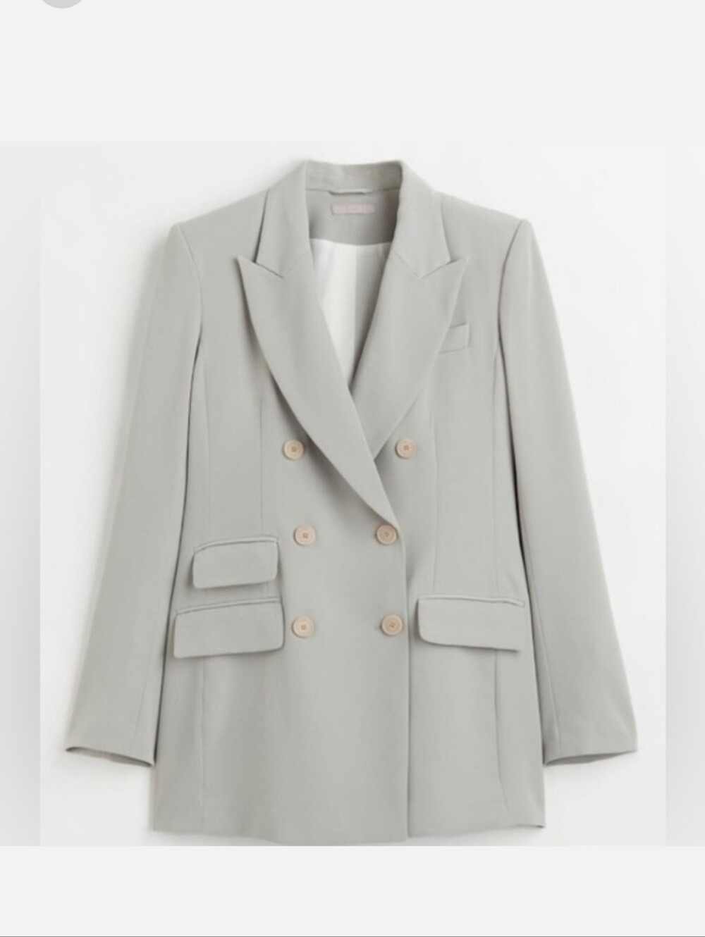 Double-breasted sage green or light grey blazer with peak lapels and front flap